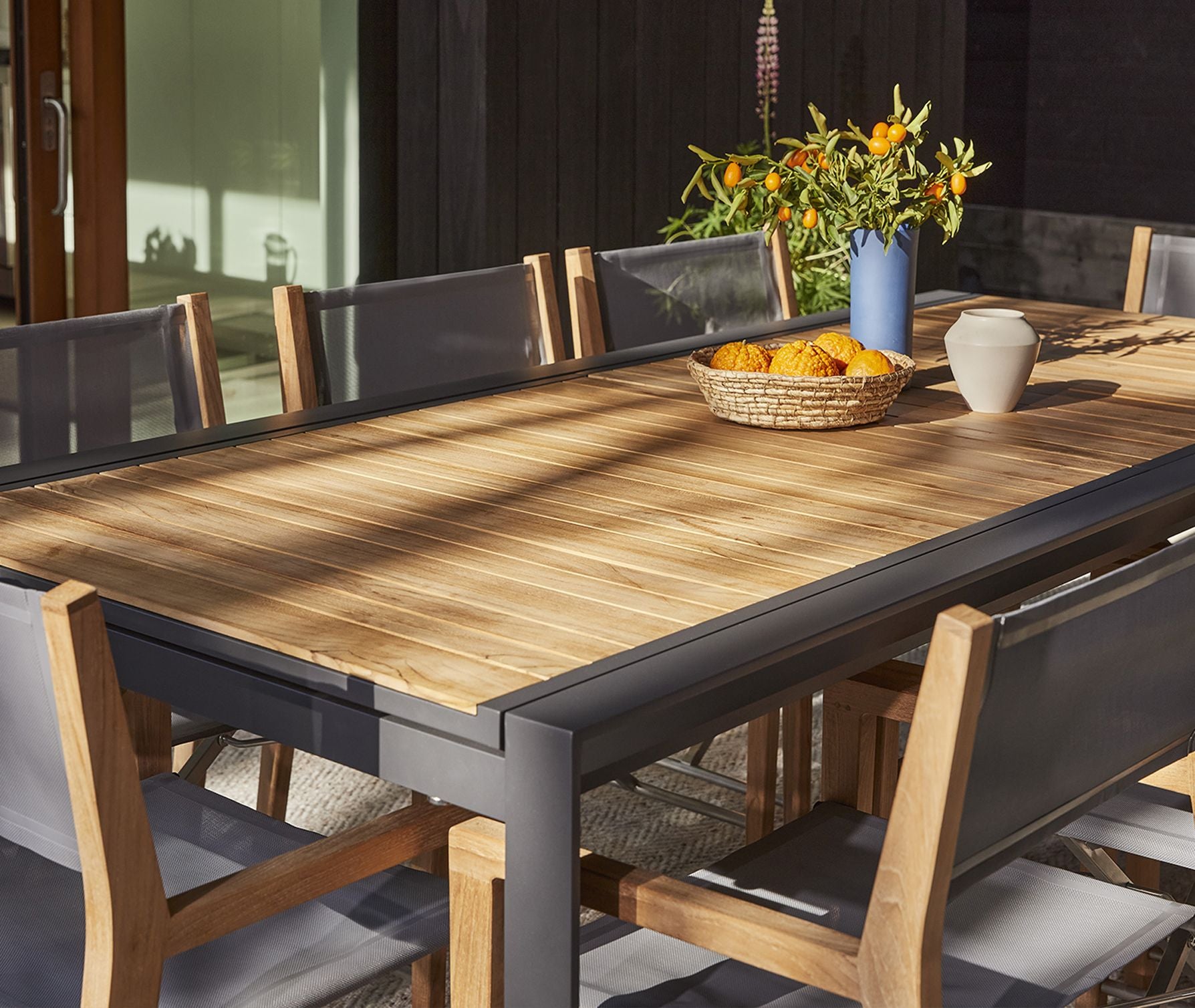 Outdoor dining table with chairs arranged for seating
