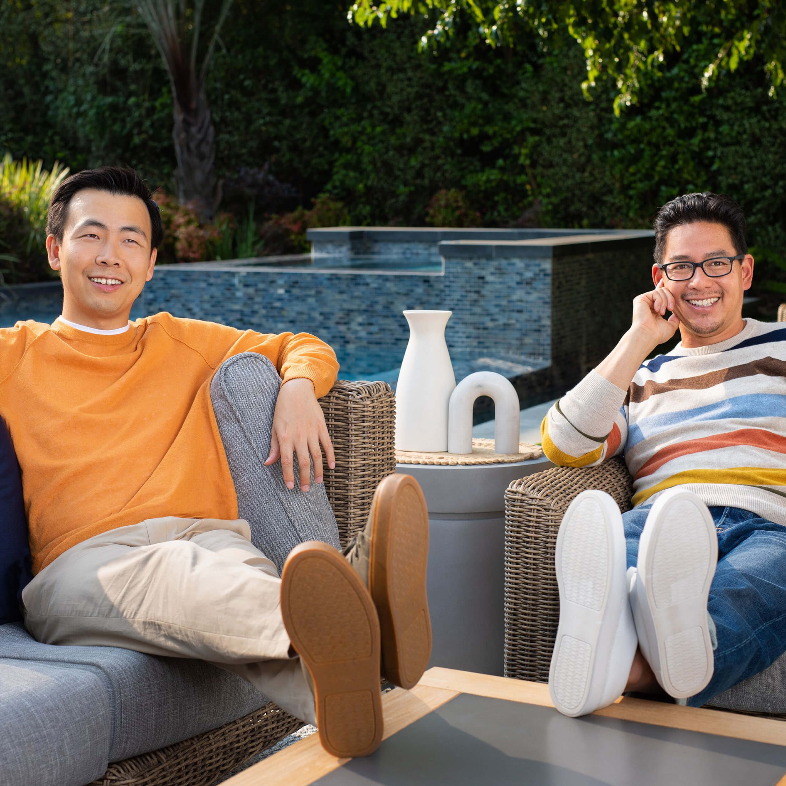 Two people relaxing on outdoor seating, reflecting the vision behind reimagining outdoor furniture
