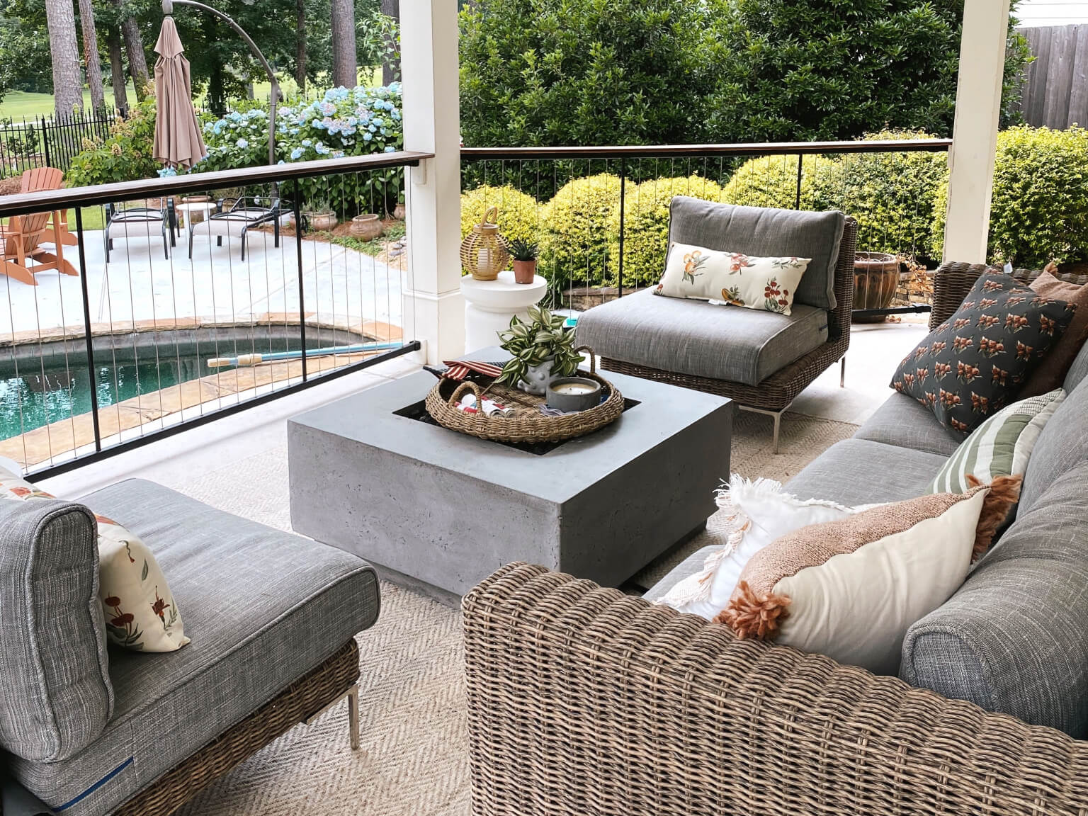 Outer outdoor sectional seating and lounge chairs arranged on a covered porch
