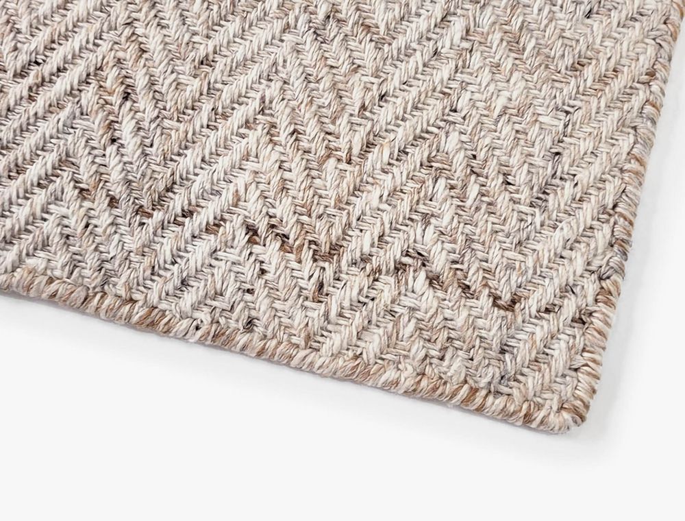 Eco-Friendly Outdoor Rug in Sand Dune Beige, corner closeup. Durable and sustainable outdoor rug made from recycled plastic bottles. #color_Sand Dune Beige