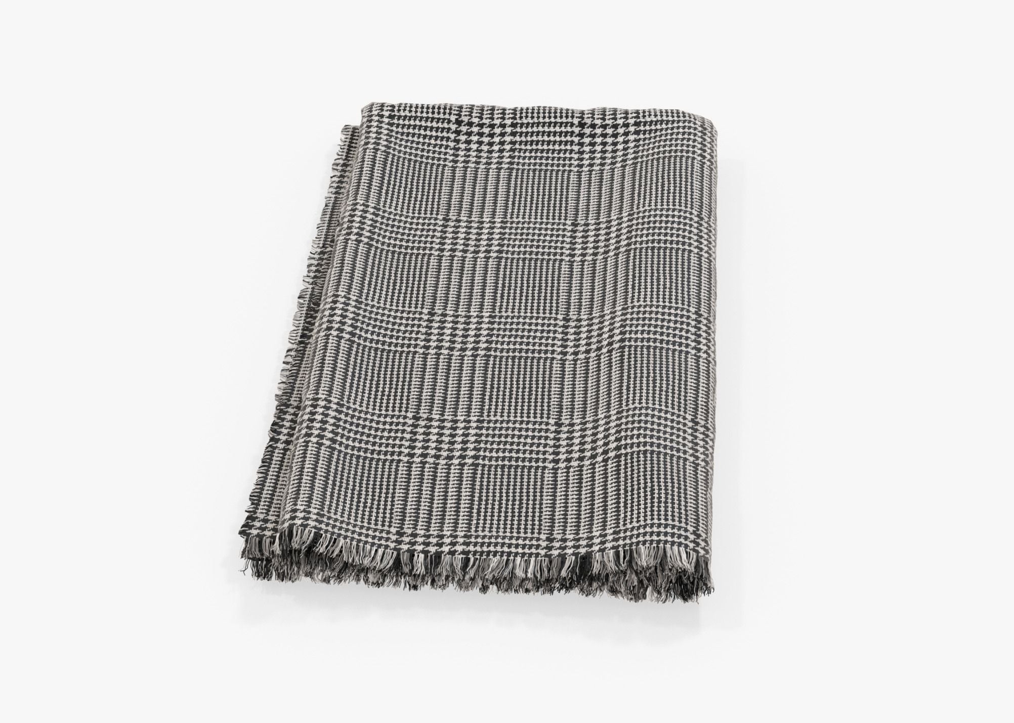 Outdoor throw blanket in Houndstooth pattern, shown folded and flat. #color_Houndstooth